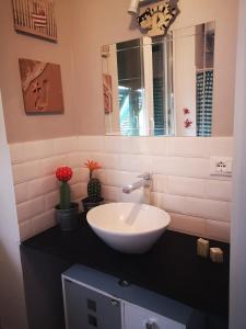 a bathroom with a white sink and a mirror at Bibi a Mare in Finale Ligure +30 photos