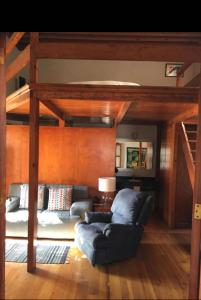 a living room with a couch and a loft bed at Quinta Luna in Cholula