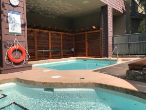a swimming pool in a building with an orange life preserver at Tyndall Stone Lodge by Whiski Jack in Whistler