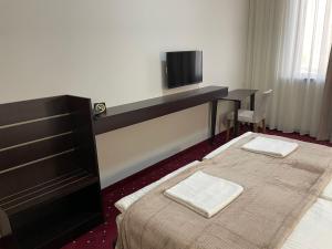 Ένα ή περισσότερα κρεβάτια σε δωμάτιο στο Anga Yerevan Hotel