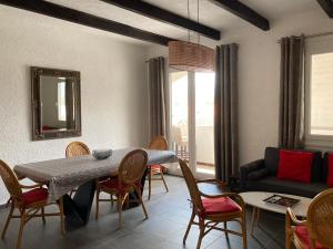 a living room with a table and chairs and a couch at Soleil Corse in Saint-Florent