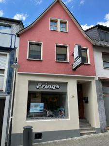 a red and white building with a store at Ferienwohnung Viventum34 in Vallendar