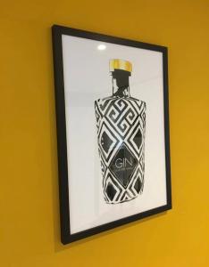 a picture of a bottle of gin on a yellow wall at Rye- Tillingham Rye - LOCATION LOCATION LOCATION! in Rye