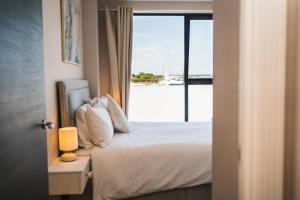 a bedroom with a bed with a view of the ocean at No. Two - Harbour Views in Poole