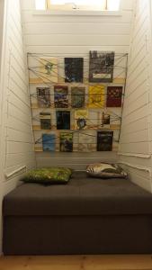 a room with a bed with a wall of books at Domek Mały Las in Rzyki
