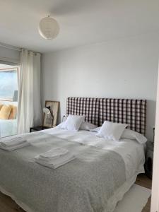 a bedroom with a large bed with towels on it at Centro VIGO.NUEVO.TOP BEST VIEWS in Vigo