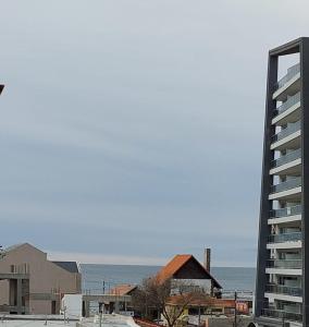 a tall building next to a large building and the ocean at AQUAMARINA 4 in Puerto Madryn