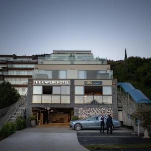 a hotel with a car parked in front of it at The Carlin Boutique Hotel in Queenstown