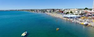 a view of a beach with a boat in the water at MAR & ARENA in Puerto Madryn