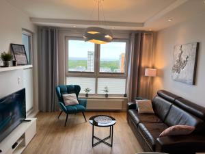 Televízia a/alebo spoločenská miestnosť v ubytovaní Apartament nad morzem BAY VIEW