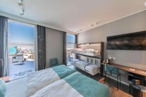 a bedroom with a large bed and a large window at Best Western Plus Hotel Ilulissat in Ilulissat