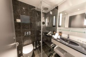 a bathroom with a toilet and a sink at Best Western Plus Hotel Ilulissat in Ilulissat