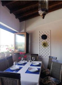 een eetkamer met een tafel en stoelen en een raam bij Αλσύλλιο - Alsillio studio apartments in Ierissos