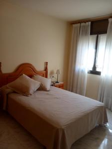 Postel nebo postele na pokoji v ubytování APARTAMENTS CASA NANDO.