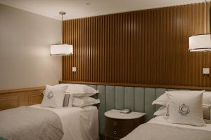 Voodi või voodid majutusasutuse The Carlin Boutique Hotel toas