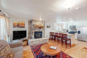 a living room with a table and a fireplace at Oso Lodge Unit B in Yosemite West