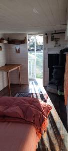 a bed in the inside of a room with a table at Los furgones de Areco in San Antonio de Areco +37 photos