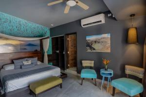 a bedroom with a bed and blue walls at Palo Verde Sustainable Hotel in El Zonte