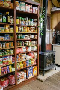 a store shelf filled with food next to a stove at Fernwood Resort in Big Sur