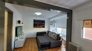 a living room with a couch and a television at APARTAMENTS B O D CoLLBLANC in Hospitalet de Llobregat +79 photos