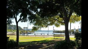 a park with a bench and a view of the water at Bayview Hotel Woy Woy in Woy Woy