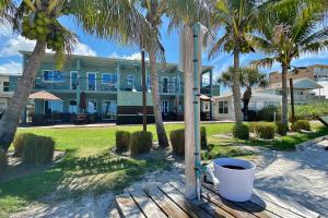 a building on the beach with palm trees at Bungalow Beach Place 6 in Clearwater Beach
