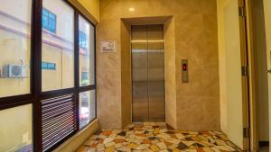 a hallway with a elevator in a building at Hotel Seniman in Kuala Lumpur