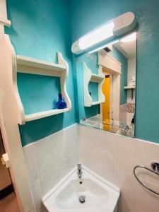 a bathroom with a sink and a mirror at 3 Bed Apartment/Explore the Area/Enjoy our Pub in Galway
