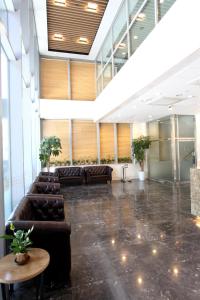 a lobby with couches and tables in a building at Hotel Skypark Dongdaemun I in Seoul