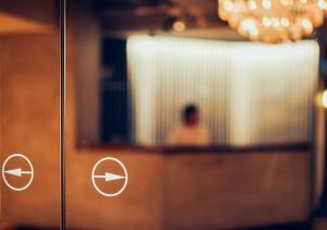 a picture of a person in a mirror at Hotel Graphy Nezu in Tokyo