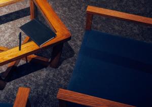 an overhead view of a desk with a book and a pen at Hotel Graphy Nezu in Tokyo