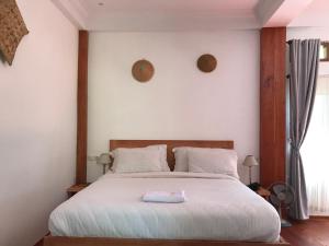 Een bed of bedden in een kamer bij Padi Ecolodge