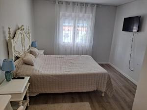 a white bedroom with a bed and a window at Casa Do Cais in Setúbal +45 photos
