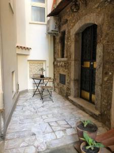 a stone courtyard with a table and chairs in a building at BEAUTIFUL in Taormina