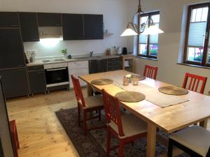 a kitchen with a wooden dining room table and chairs at APARTMENT ZUM ROTEN TOR in Spitz