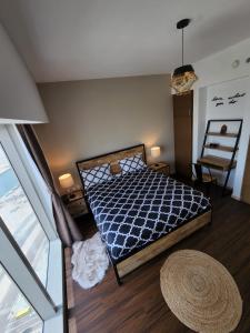 a bedroom with a bed and a table and a window at Cozy 1BR in Iconic Tower in Abu Dhabi