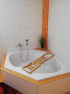 a bath tub with a wooden tray in it at Ferienwohnung Nico in Stadtilm