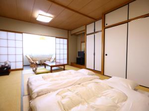 Voodi või voodid majutusasutuse Hotel Yudanaka toas