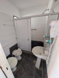 a bathroom with two toilets and a sink at Santa Catalina Hotel in San Antonio de Areco
