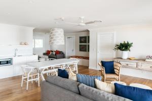a living room with a couch and a table at The Patonga Hotel in Patonga Beach