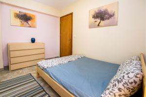 - une chambre avec un lit et une commode dans l'établissement BELUGA HOUSE, à Skala Rachoniou