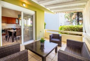 a patio with a table and chairs and a kitchen at BELUGA HOUSE in Skala Rachoniou