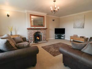 a living room with two couches and a fireplace at Cherry Garth in Whitby