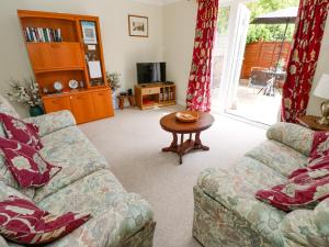 a living room with a couch and a table at Westmount in Ryde