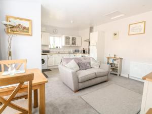 a living room with a couch and a table at Jimmys Place in Diss