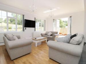 a living room with two couches and a tv at Castle Top Retreat in Market Rasen