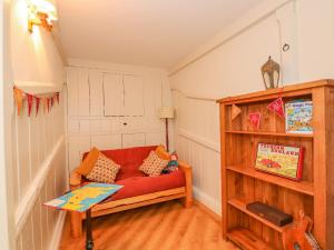 a living room with a red couch and a table at The Stables in Millom