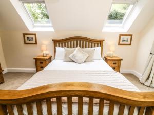 a bedroom with a large bed with skylights at The Coach House in Carnforth