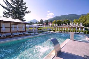 a large swimming pool with chairs and umbrellas at 7 Lakes camping in Sapareva Banya