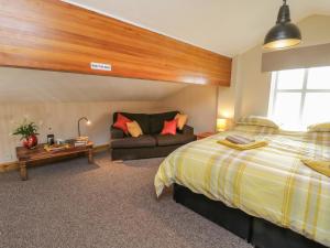a bedroom with a bed and a couch at The Old Church in York